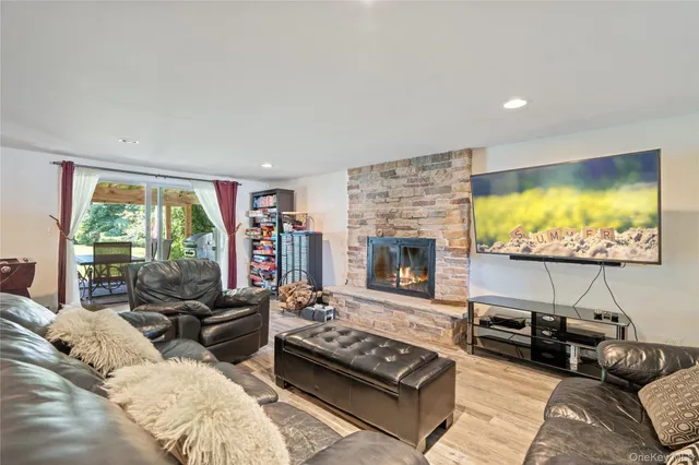 a living room with furniture flat screen tv and a fireplace