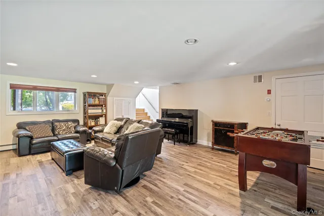 a living room with furniture a fireplace and a wooden floor