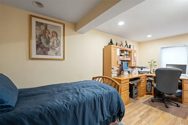 a view of a workspace with furniture and a window