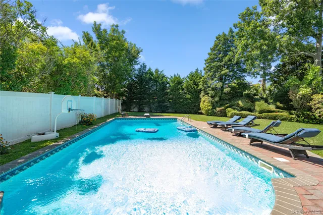 a view of a backyard with swimming pool