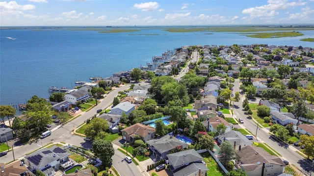 an aerial view of a residential houses with outdoor space and swimming pool