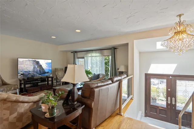 a living room with furniture a large window and a flat screen tv