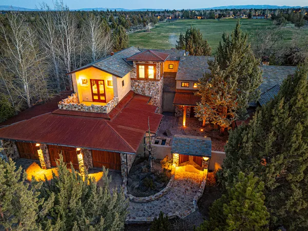 an aerial view of a house with a yard