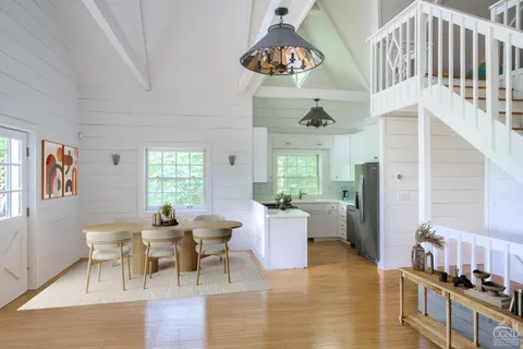 a view of a dining room with furniture window and wooden floor