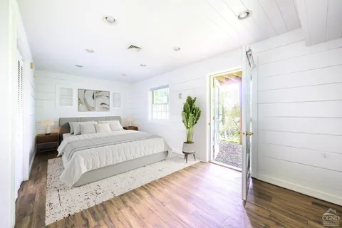 a spacious bedroom with a bed and a window