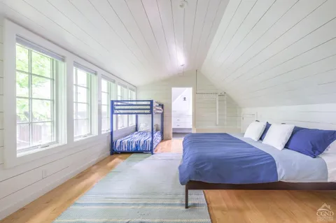 a spacious bedroom with a bed and a large window