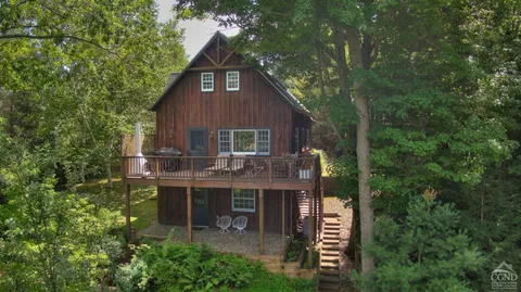 a view of house with yard outdoor seating and green space
