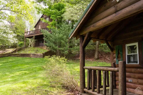 a view of a porch with a floor to ceiling window and tree