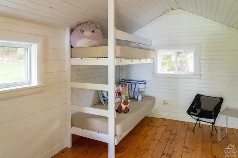 a bedroom with a bed and a chair