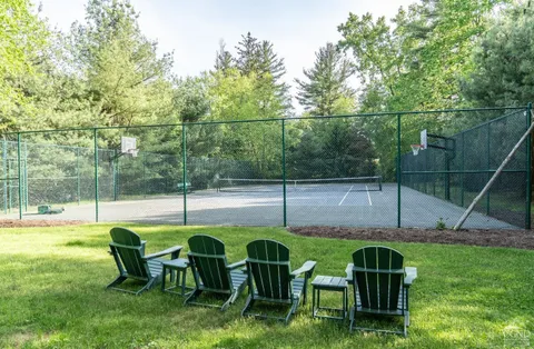 a view of an chairs and table in the yard