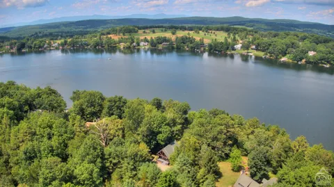 a view of a lake with houses in the back