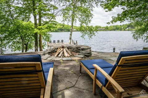a view of a patio with chairs and a table