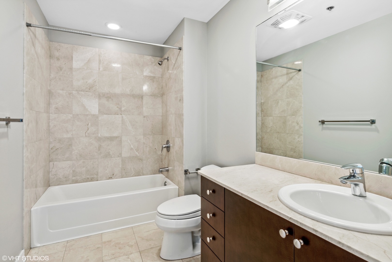 Undisclosed Address Chicago, IL 60654 - Photo 13 of 22 a bathroom with a bathtub shower sink mirror vanity and a toilet