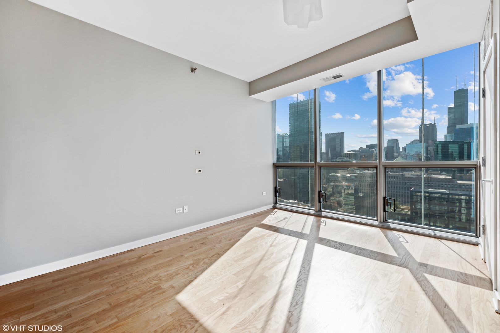 Undisclosed Address Chicago, IL 60654 - Photo 3 of 22 a view of a room with wooden floor and city view