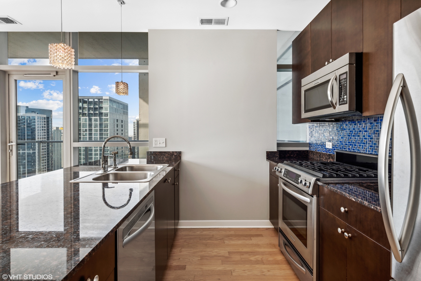 Undisclosed Address Chicago, IL 60654 - Photo 5 of 22 a kitchen with stainless steel appliances granite countertop a sink stove and cabinets