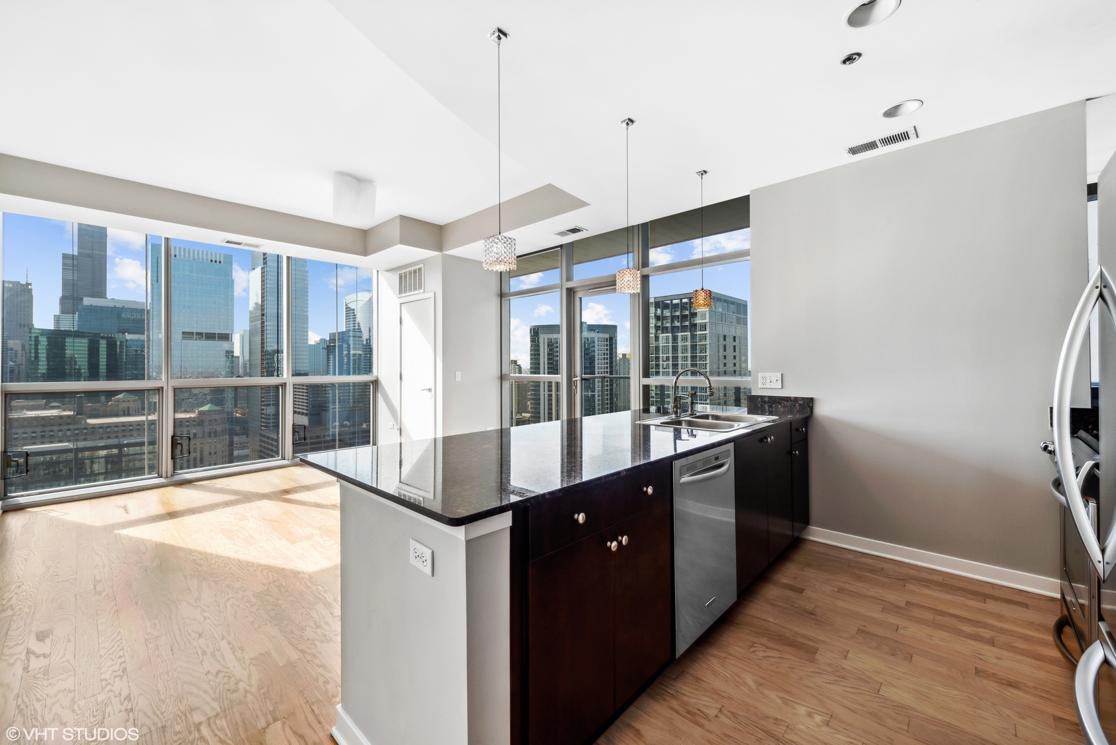 Undisclosed Address Chicago, IL 60654 - Photo 6 of 22 a large kitchen with a large window and stainless steel appliances