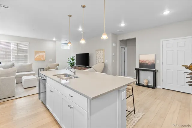 a kitchen that has a sink a stove and a table