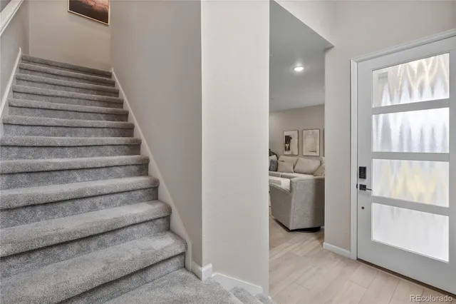 a view of entryway and hall with wooden floor