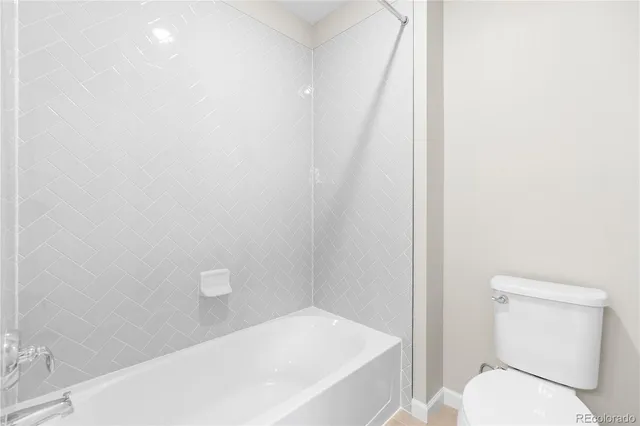 a bathroom with a toilet and a bathtub