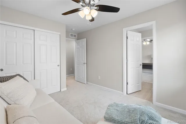 a living room with furniture and a ceiling fan