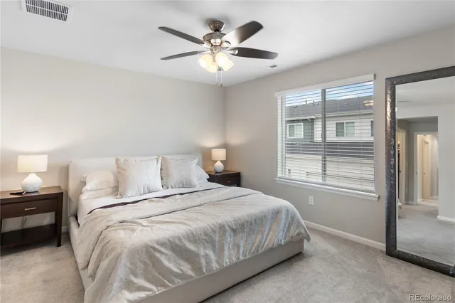 a bedroom with a large bed and a chandelier