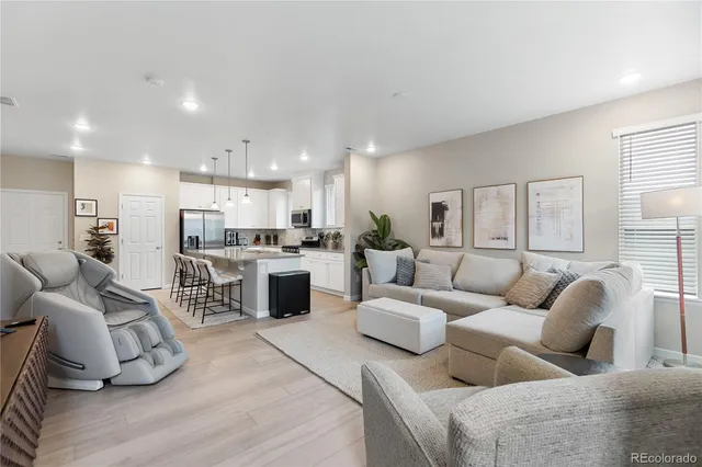 a living room with furniture and kitchen view