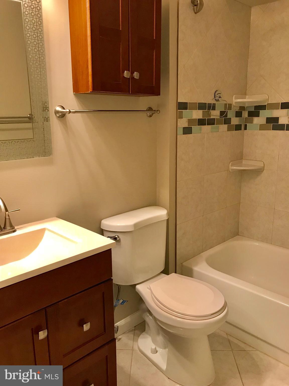 7702 Lexton Place, Unit 65 Springfield, VA 22152 - Photo 18 of 24 a bathroom with a toilet a sink and bathtub
