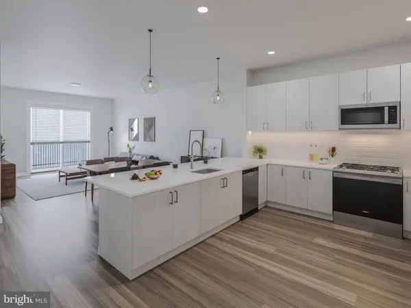 a living room with lots of furniture and kitchen view