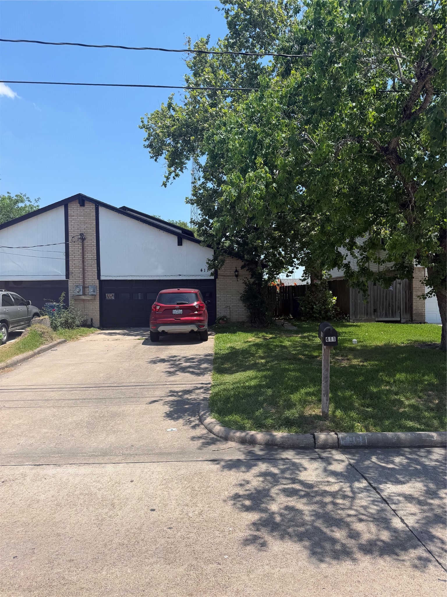 411 South Austin Street Webster, TX 77598 - Photo 1 of 13 a front view of a house with a yard