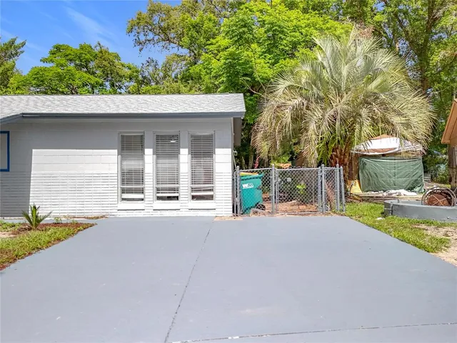 a house with a yard and a large tree