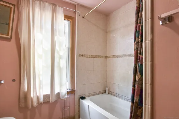 a bathroom with a tub and shower