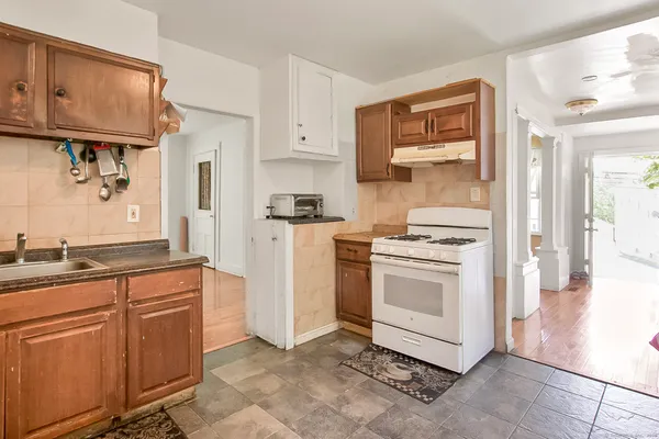 a kitchen with granite countertop cabinets stainless steel appliances and a sink