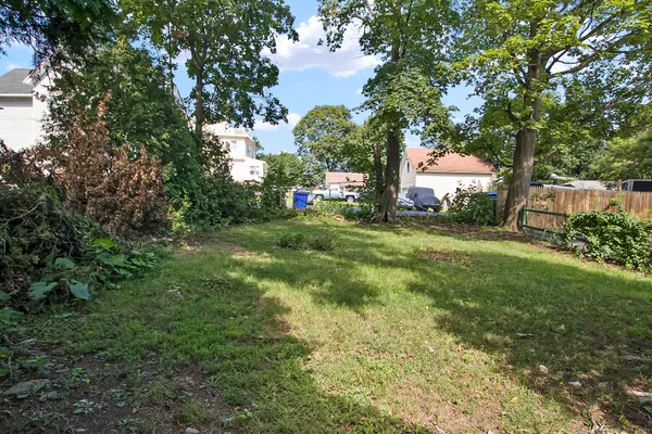 a view of a trees and barn in the back yard