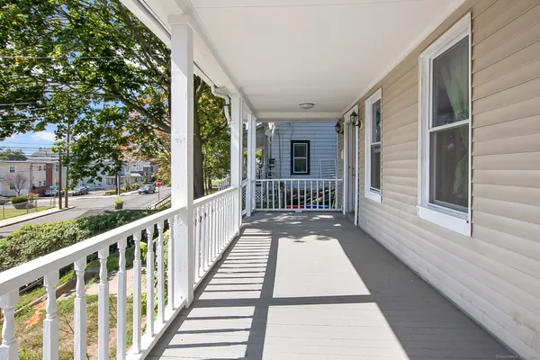 a view of a porch with wooden floor and fence