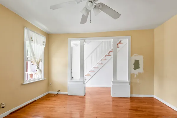wooden floor in an empty room with a window