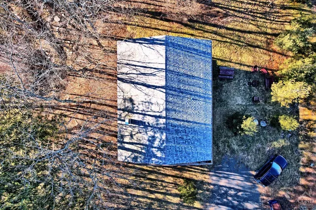 a bedroom with a bed couch and a window