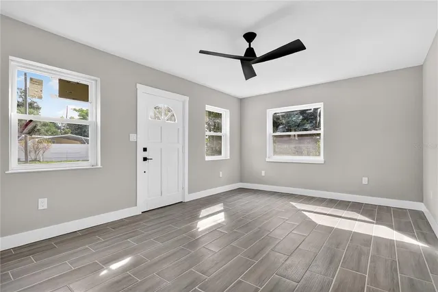 a view of empty room with wooden floor