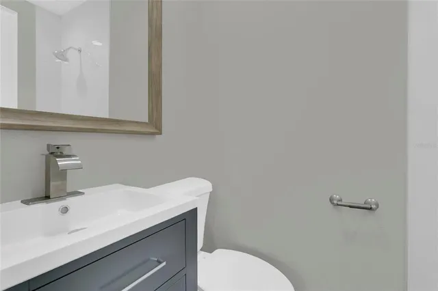 an empty room with a window and a ceiling fan