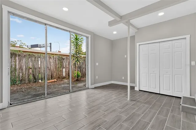 a view of house with yard and trees in the background