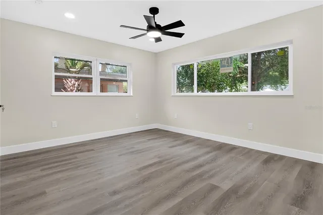 a bathroom with a toilet sink vanity and mirror