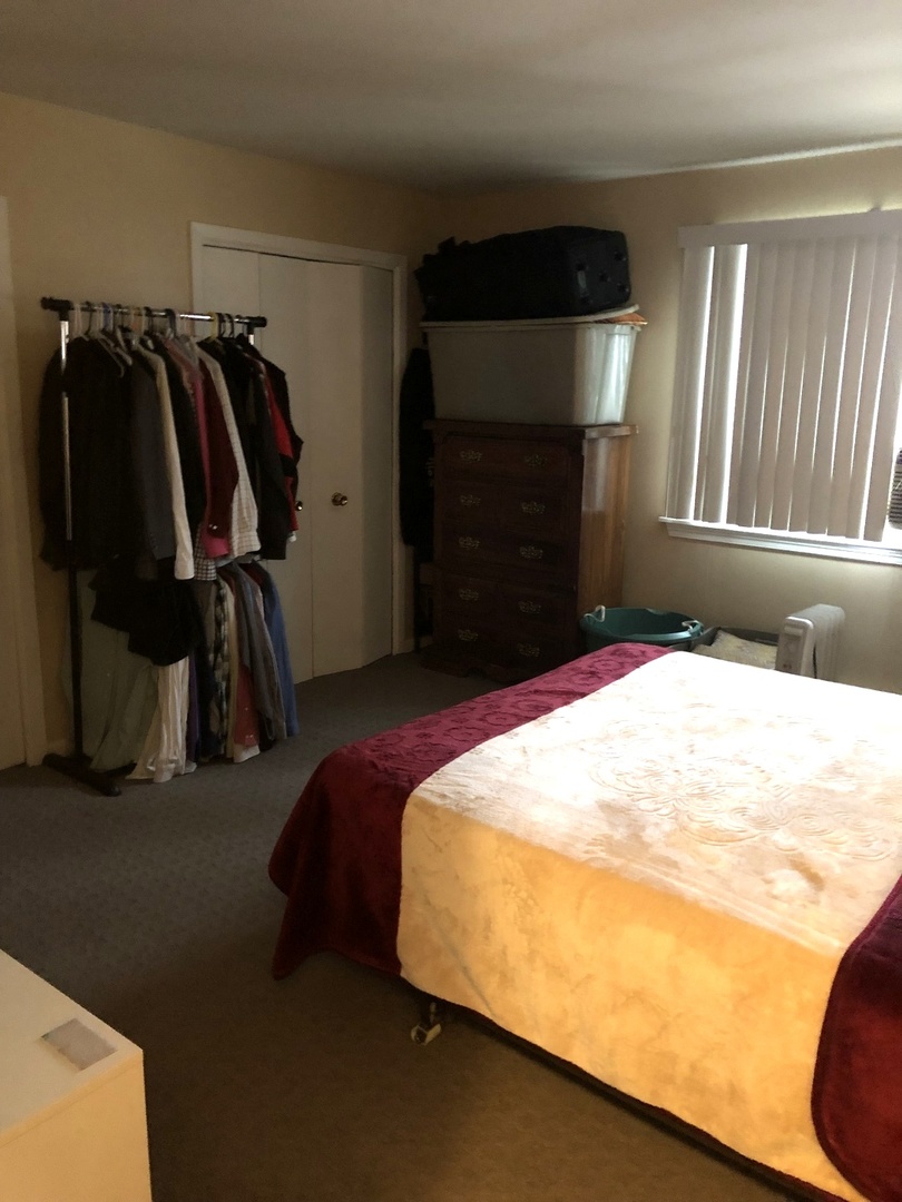 296 Dee Road North Aurora, IL 60542 - Photo 3 of 5 a bed sitting in a bedroom next to a window