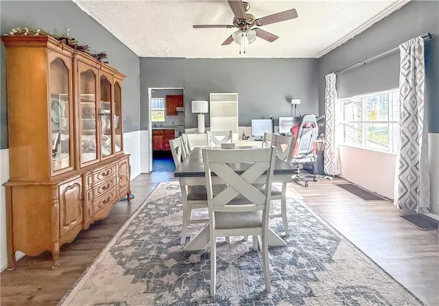 a dining room with furniture window and wooden floor