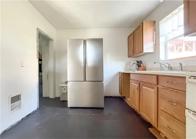 a kitchen with a refrigerator sink stove and cabinets
