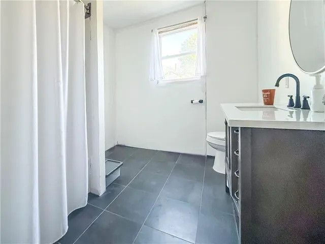 a room with a sink and a mirror