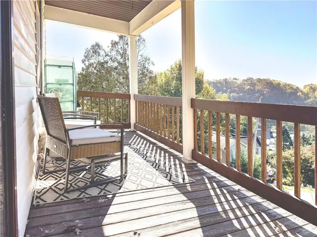 a view of a balcony with wooden floor