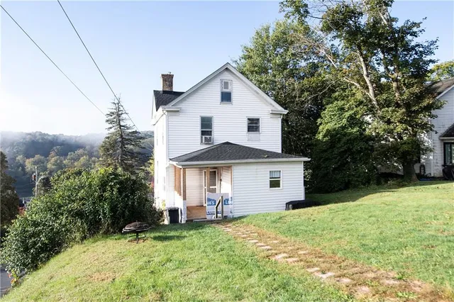 a front view of a house with a yard