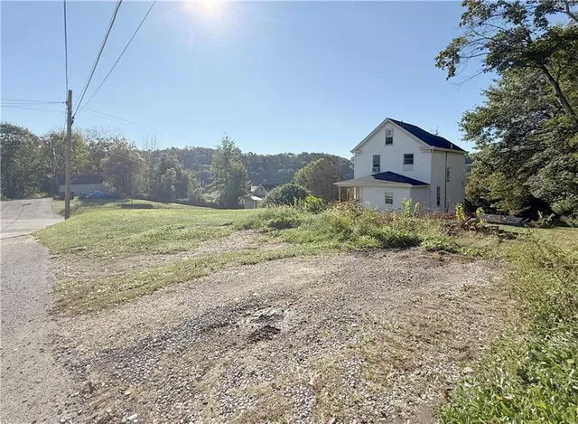 a big house with a big yard and large trees