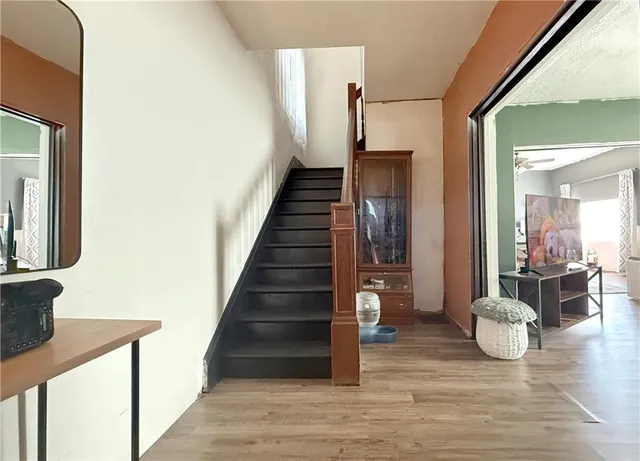 a view of a hallway view with wooden floor and staircase