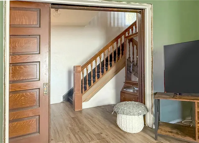 a view of entryway and hall with wooden floor