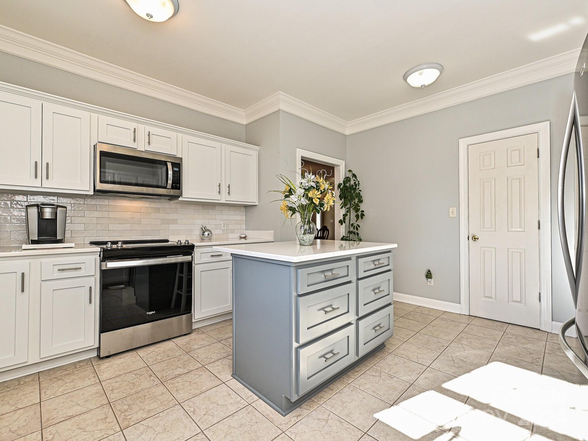 3203 Bentley Drive Lancaster, SC 29720 - Photo 16 of 45 a kitchen with stainless steel appliances kitchen island granite countertop a stove and a sink